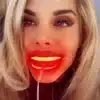 A woman with a REDi Lumident with Power Pack glowing mouth is posing for a photo.