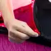 A person immersing in red light therapy by opening a REDi Infuse Plus LED mattress cover., red light therapy