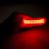 A person holding a REDi Lumident with Power Pack bike light.