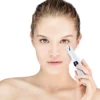 A woman is holding a REDi Retouch over her face.